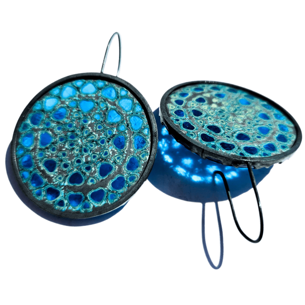 blue earrings reflecting